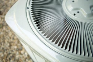 Close-up view of white HVAC cooling system fins showing detailed air intake vents and mechanical components.