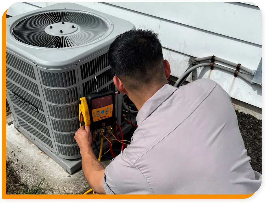 HVAC tech working on residential AC unit