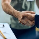 Close-up,Of,Mechanic,And,Maintenance,Engineer,Shaking,Hands,At,Car